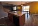 Kitchen island with sink and dishwasher, complemented by adjacent table and chairs at 3229 S 93Rd Ave, Tolleson, AZ 85353