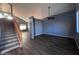 Open concept living room with hardwood floors, staircase, and lots of light at 3229 S 93Rd Ave, Tolleson, AZ 85353
