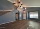 Bright living room features hardwood floors, staircase, and high ceiling at 3229 S 93Rd Ave, Tolleson, AZ 85353