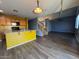 Open-concept floor plan with kitchen island, wood-look floors and staircase at 3229 S 93Rd Ave, Tolleson, AZ 85353