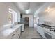 Spacious kitchen featuring white cabinets, tiled countertops, and stainless steel appliances at 335 W Cambridge Ave, Phoenix, AZ 85003