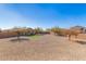 Large backyard featuring gravel, artificial turf, and mature trees for shade at 35344 N Karan Swiss Cir, San Tan Valley, AZ 85143