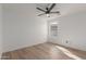 Bedroom with wood flooring, ceiling fan, and a window allowing ample natural light at 35344 N Karan Swiss Cir, San Tan Valley, AZ 85143
