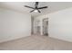 Spacious bedroom features neutral carpet, ceiling fan, walk-in closet, and an ensuite bathroom at 35344 N Karan Swiss Cir, San Tan Valley, AZ 85143