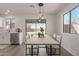 Bright dining area with modern pendant lights and a sliding glass door at 35344 N Karan Swiss Cir, San Tan Valley, AZ 85143