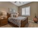 Cozy bedroom with wooden furniture, soft lighting, and shuttered windows at 3556 E Tiffany Way, Gilbert, AZ 85298