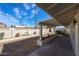 View of the backyard, including the block wall, planter boxes, and covered patio at 3716 W Griswold Rd, Phoenix, AZ 85051