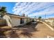 Spacious backyard featuring desert landscaping and mature palm trees with a sliding glass door entry at 3716 W Griswold Rd, Phoenix, AZ 85051