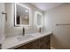 Bathroom with double vanity, quartz countertop, shaker cabinets, and dual, lighted mirrors at 3716 W Griswold Rd, Phoenix, AZ 85051