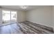Inviting bedroom with wood-look floors and a sliding glass door leading outside at 3716 W Griswold Rd, Phoenix, AZ 85051