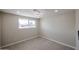 Neutral toned bedroom features new tile flooring and a large picture window to maximize light at 3716 W Griswold Rd, Phoenix, AZ 85051