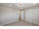 Neutral bedroom featuring tile floors, closet doors, and access to other rooms at 3716 W Griswold Rd, Phoenix, AZ 85051