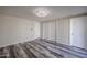 Bright bedroom featuring wood-look floors, ample closet space, and updated lighting at 3716 W Griswold Rd, Phoenix, AZ 85051