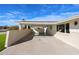 Spacious covered carport with brick accents and ample parking space, with grass in the yard at 3716 W Griswold Rd, Phoenix, AZ 85051