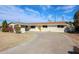 Charming single-story home features a vibrant yellow door and manicured landscaping, complete with a large driveway at 3716 W Griswold Rd, Phoenix, AZ 85051