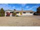 Charming single-story home features a vibrant yellow door and well-manicured landscaping, complete with a large driveway at 3716 W Griswold Rd, Phoenix, AZ 85051