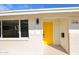Close-up of the home's entryway features a bright yellow door, stylish lighting, and clear address number at 3716 W Griswold Rd, Phoenix, AZ 85051