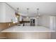 Beautiful kitchen with a breakfast bar, white cabinetry, and updated appliances at 3716 W Griswold Rd, Phoenix, AZ 85051