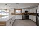 Modern kitchen boasts white cabinets, stainless steel appliances, and an oversized countertop at 3716 W Griswold Rd, Phoenix, AZ 85051