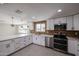 Modern kitchen with stainless steel appliances, granite countertops, and white cabinets at 3716 W Griswold Rd, Phoenix, AZ 85051