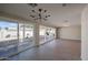 Bright living room with tile floors, modern lighting, and sliding glass doors to the backyard at 3716 W Griswold Rd, Phoenix, AZ 85051