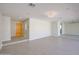 Open-concept living room with tiled floors, recessed lighting, and an inviting yellow door at 3716 W Griswold Rd, Phoenix, AZ 85051