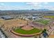 Captured from above, this community features sports fields, baseball diamonds, and a running track against a stunning mountain backdrop at 37292 N Yellowstone Dr, San Tan Valley, AZ 85140