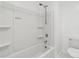 Bathroom shower and tub combo with white tile and adjustable shower head at 37292 N Yellowstone Dr, San Tan Valley, AZ 85140