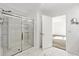 Well-lit bathroom featuring a glass shower with a tile surround, bright white walls and tile flooring at 37292 N Yellowstone Dr, San Tan Valley, AZ 85140