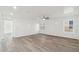 Bedroom featuring wood-look floors, a ceiling fan, and two windows at 37292 N Yellowstone Dr, San Tan Valley, AZ 85140