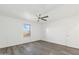 Bright bedroom with wood-look floors, a window, and a ceiling fan at 37292 N Yellowstone Dr, San Tan Valley, AZ 85140