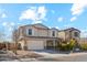 Two-story home featuring a two-car garage, neutral stucco, shuttered windows, and low maintenance landscaping at 37292 N Yellowstone Dr, San Tan Valley, AZ 85140