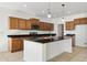 Kitchen with wooden cabinetry, stainless steel appliances, granite countertops, and a kitchen island with a sink at 37292 N Yellowstone Dr, San Tan Valley, AZ 85140