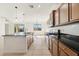 Kitchen with wooden cabinetry, stainless steel appliances, granite countertops, and a kitchen island with a sink at 37292 N Yellowstone Dr, San Tan Valley, AZ 85140