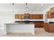 Kitchen with wooden cabinetry, stainless steel appliances, granite countertops, and a kitchen island with a sink at 37292 N Yellowstone Dr, San Tan Valley, AZ 85140