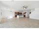 Open floor plan with neutral tile flooring that connects the living room to the kitchen at 37292 N Yellowstone Dr, San Tan Valley, AZ 85140