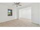 Living room with neutral tile flooring, ceiling fan, and a large window at 37292 N Yellowstone Dr, San Tan Valley, AZ 85140