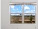 A view of distant hills and a blue sky with white clouds is seen through this window at 37292 N Yellowstone Dr, San Tan Valley, AZ 85140