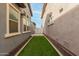 This house features a backyard with pavers, turf, and neutral-colored siding at 3868 E Robert St, Gilbert, AZ 85295