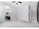 Bedroom with plush carpet, ceiling fan, en suite bath with double sinks, door to walk in closet at 3868 E Robert St, Gilbert, AZ 85295