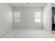 The bedroom features a carpeted floor, neutral colored walls and two large windows at 3868 E Robert St, Gilbert, AZ 85295