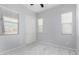 This bedroom is well-lit with three windows and plush carpeting at 3868 E Robert St, Gilbert, AZ 85295