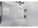 Bright bedroom features plush carpet, ceiling fan, and view to bathroom at 3868 E Robert St, Gilbert, AZ 85295