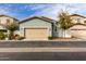 Single-story home featuring a tan garage door and desert landscaping at 3868 E Robert St, Gilbert, AZ 85295