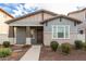 Attractive home featuring a covered porch, stylish color palette, and meticulously maintained front yard at 3868 E Robert St, Gilbert, AZ 85295
