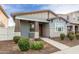 Well-kept home with a welcoming front porch, coordinating color scheme, and carefully manicured landscaping at 3868 E Robert St, Gilbert, AZ 85295