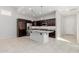 Bright kitchen with a large island, stainless steel refrigerator, and ample cabinet space at 3868 E Robert St, Gilbert, AZ 85295