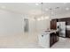 Open concept kitchen with a granite island, stainless steel appliances, and modern lighting at 3868 E Robert St, Gilbert, AZ 85295