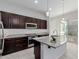 Kitchen with a granite island, stainless steel oven and microwave and sliding glass doors to the patio at 3868 E Robert St, Gilbert, AZ 85295