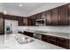 Granite-topped kitchen island and countertops, stainless appliances, and custom cabinets at 3868 E Robert St, Gilbert, AZ 85295